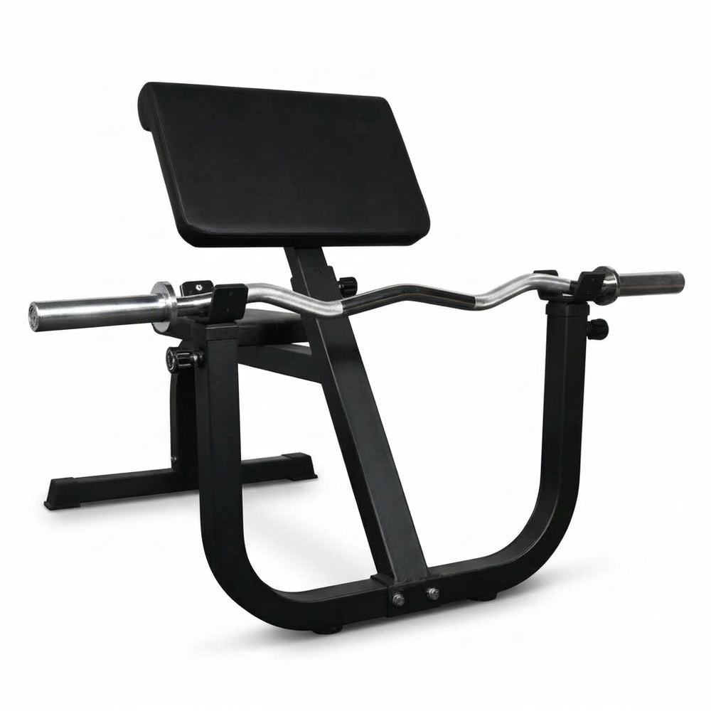 Black gym machine on a dark floor with a white wall background