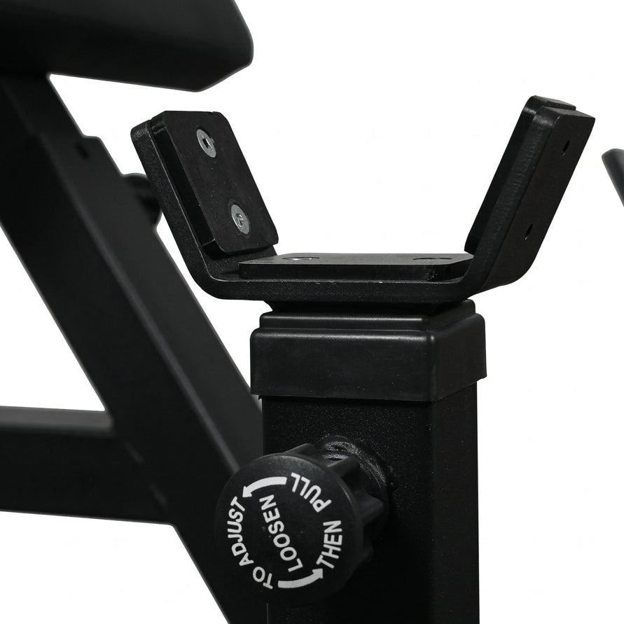 Close-up of a black exercise machine with a focus on the seat post and control knob.