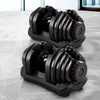 Pair of adjustable dumbbells on a marble surface