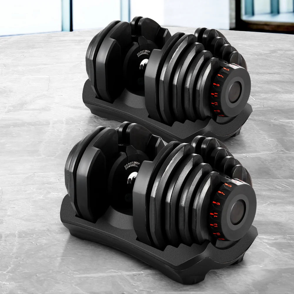 Pair of adjustable dumbbells on a marble surface