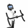 A close-up of a fitness exercise bike's handlebar assembly, featuring black curved grips, a silver metal frame, and a black digital display screen mounted on the handlebar stem, set against a plain white background.