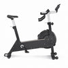 A black and silver indoor stationary exercise bike with a digital display on the handlebars, shown from a side profile on a white background.