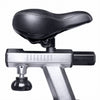 Close-up of a bicycle saddle mounted on a silver and black indoor trainer frame