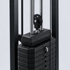 Stack of black weight plates on a gym machine with a blurred background