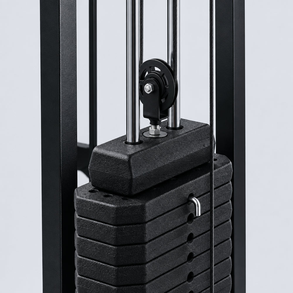 Stack of black weight plates on a gym machine with a blurred background