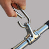 Hand holding a chrome metal tool with a gray background