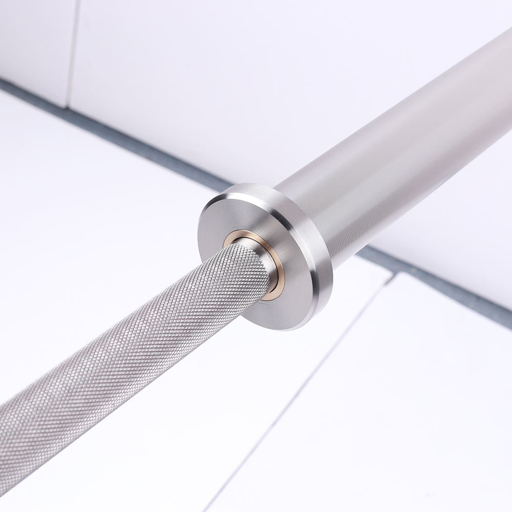 Close-up of a metallic barbell with a knurled textured grip and a polished steel end on a clean white background.