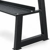Black metal shelf of a kettlebell rack on a white background