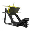 A leg extension gym machine in black and orange, shown from a three-quarters angle on a light gray studio background.