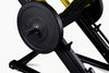 Close-up of a weight plate on a weightlifting bench with a white background