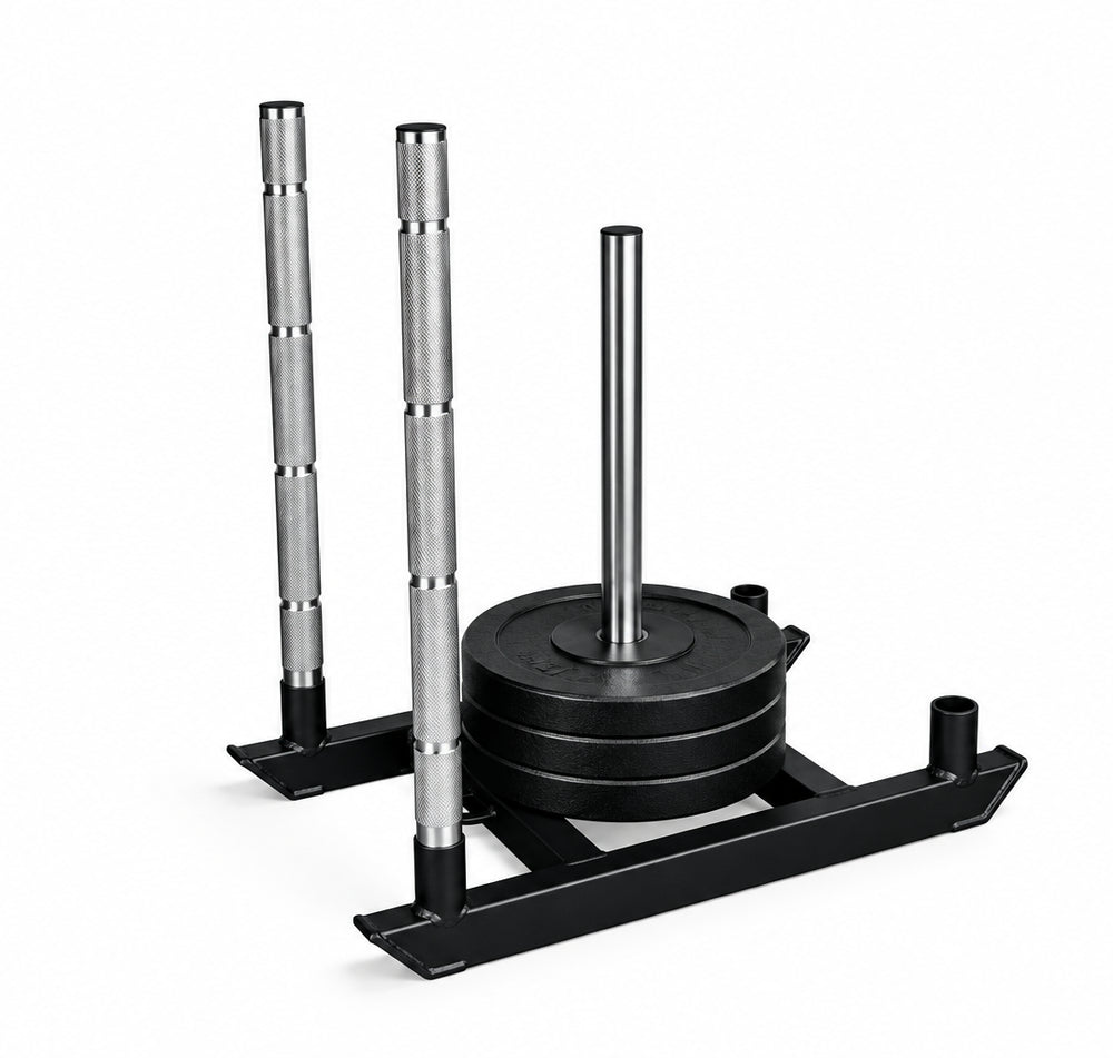 Black weight plates loaded onto a commercial power sled on a white background