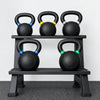 Set of kettlebells on a rack with a white background