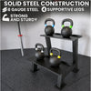 Black metal kettlebell stand with kettlebells on a gray floor, emphasizing solid steel construction.