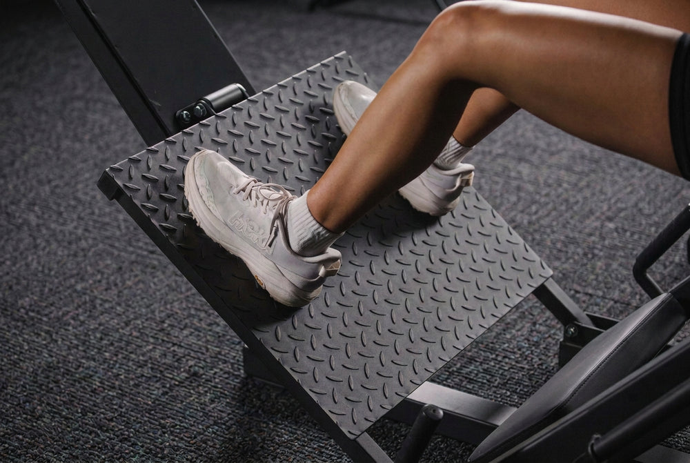 Person using a step machine on a green floor