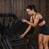 Woman using a leg press machine in a gym setting