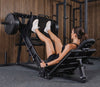 Person using a leg press machine in a gym setting
