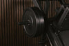 Close-up of weight plates on a barbell against a dark background