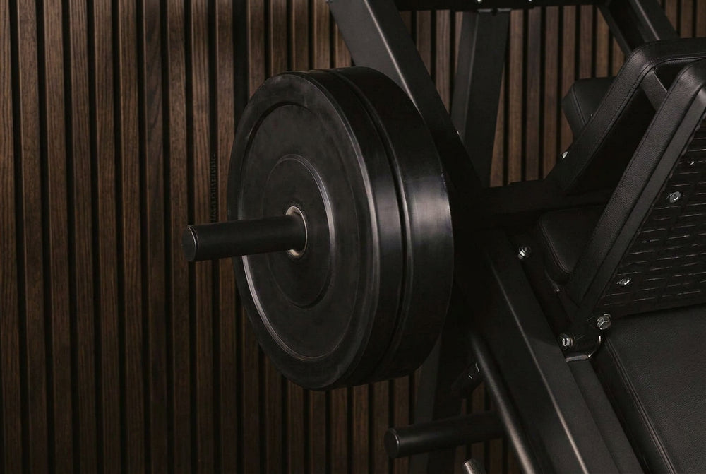 Close-up of weight plates on a barbell against a dark background