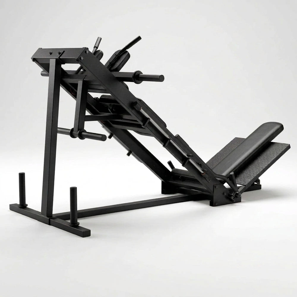 A black industrial leg extension gym machine with a foot platform and adjustable frame.