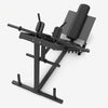 A black metal leg extension gym machine with padded backrest and foot platform.