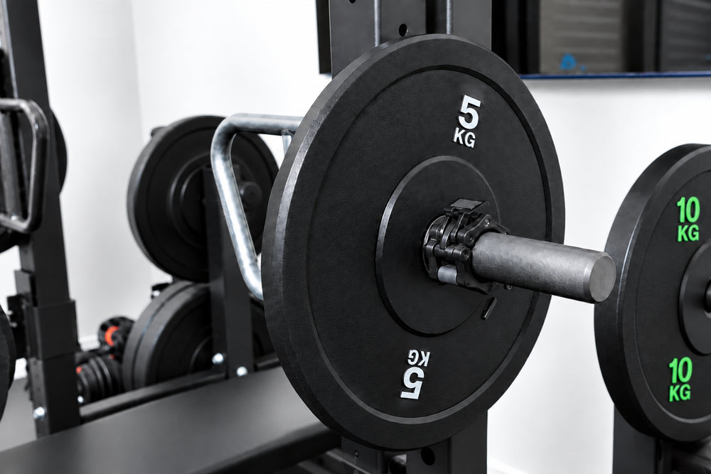 Close-up of a black barbell with weight plates in a gym setting.