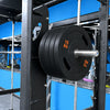 Olympic coloured bumper lates on a barbell gym machine in a gym setting