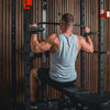 Person exercising on a pull-up bar in a gym setting