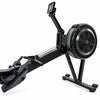 A black rowing machine with an attached digital display screen and foot pedals, photographed on a plain white background.