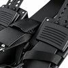 Close-up of black footrests with textured grip pads and adjustable straps on a white background.