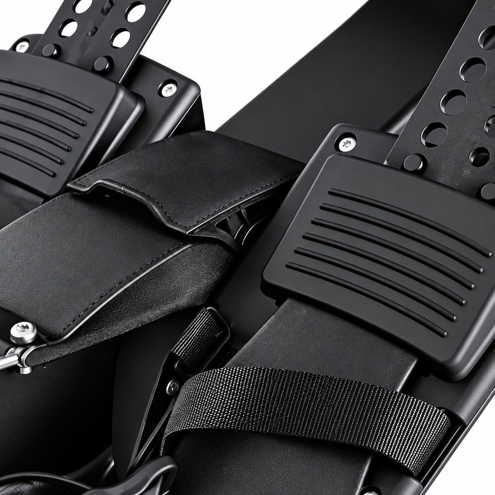 Close-up of black footrests with textured grip pads and adjustable straps on a white background.