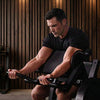 Man exercising on a weight machine in a gym setting