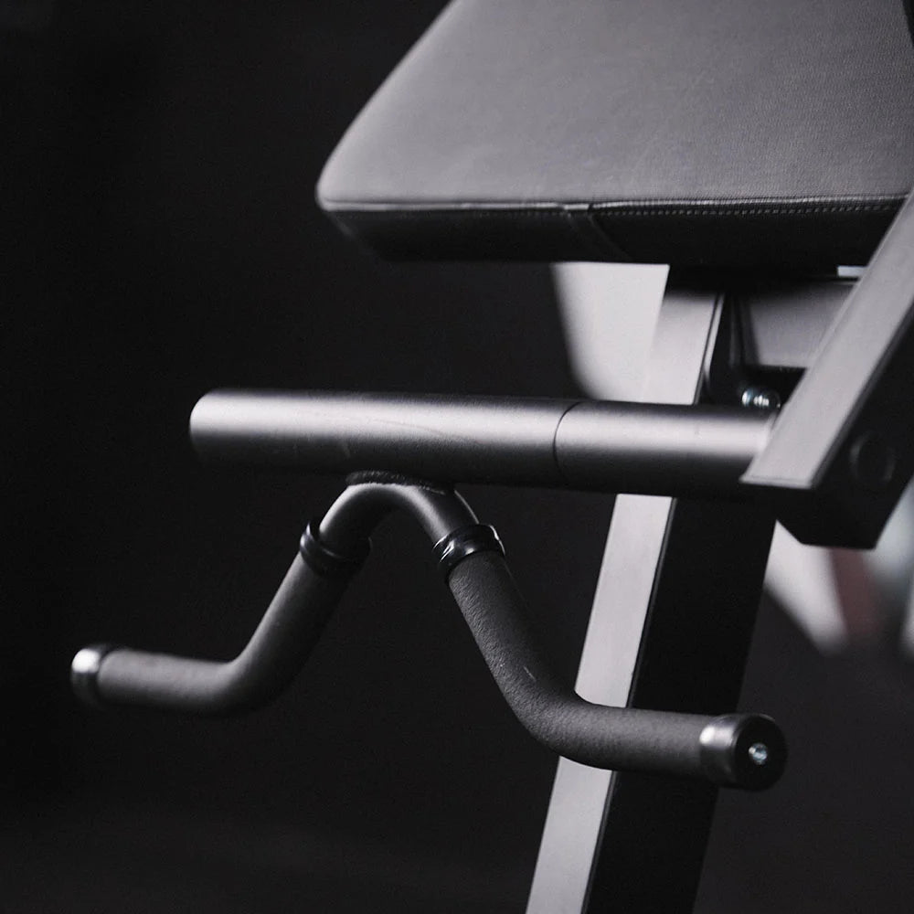 Close-up of a black exercise bike with a dark background