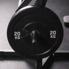 Close-up of a weight plate on a barbell with a blurred background