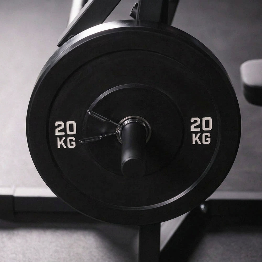 Close-up of a weight plate on a barbell with a blurred background