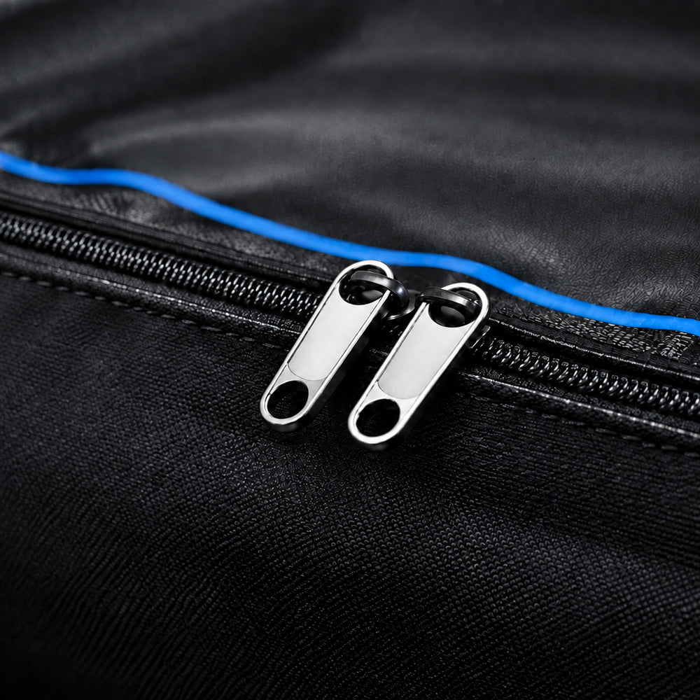 Close-up of a black bag with metal zippers