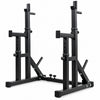 Black steel squat rack with dual uprights, safety arms, and foot pegs on a plain white background.