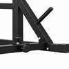 Close-up of a red and black metal weight bench frame with adjustment knobs and a black handle, shown on a light wood floor against a textured white wall.