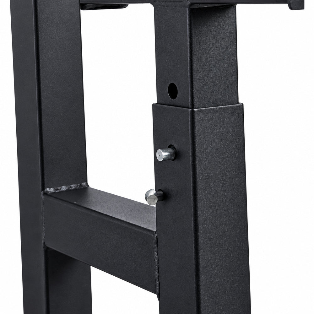 Close-up of a black metal frame with screws on a white background