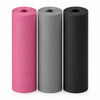 3 rolled up yoga mats in grey, black and pink on a white background