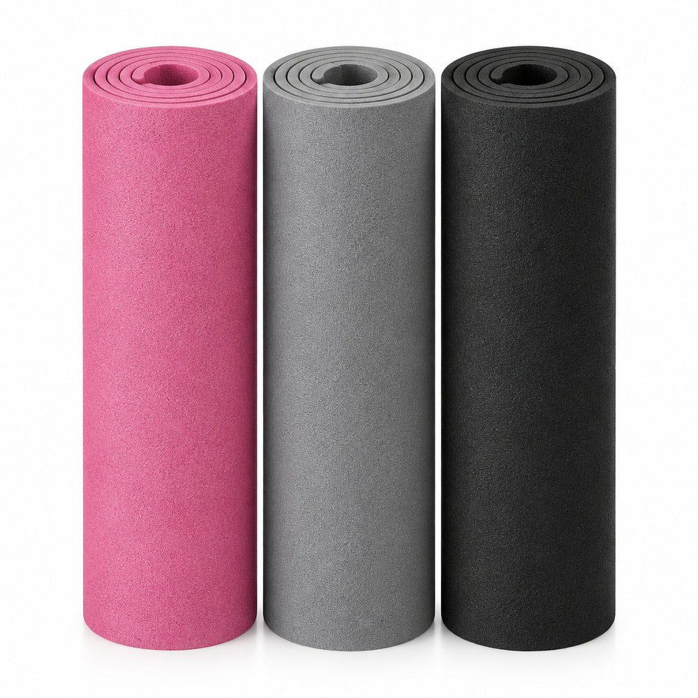 3 rolled up yoga mats in grey, black and pink on a white background