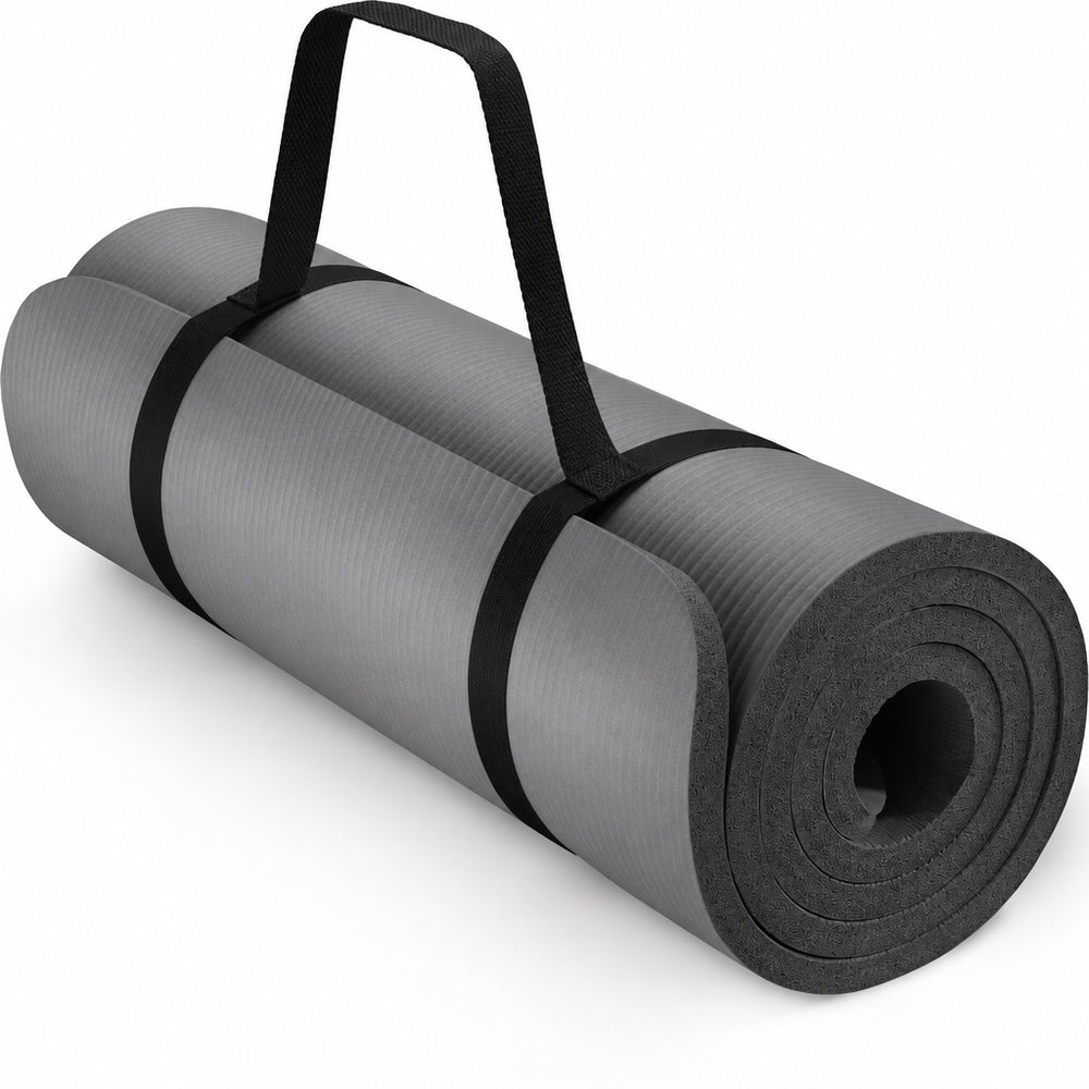 Grey yoga mat rolled up with carry strap on a white background