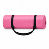 A pink rolled-up yoga mat with black carrying straps, shown on a clean white background. 