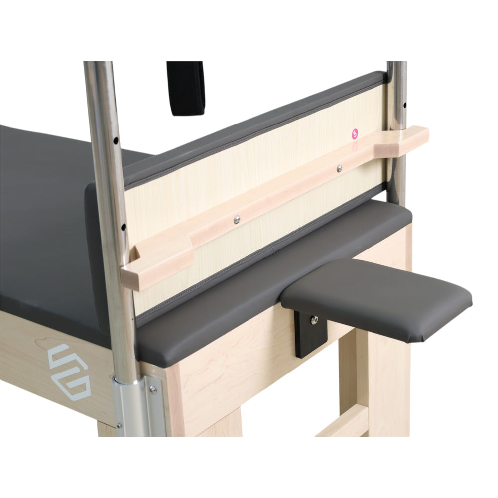 Close-up of the end panel, armrest and adjustment pin on the dark grey Cadillac reformer