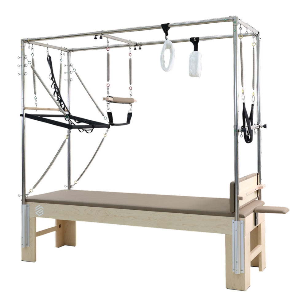 Side angle view of the GS Essential Cadillac Reformer in light brown Pilates trapeze table