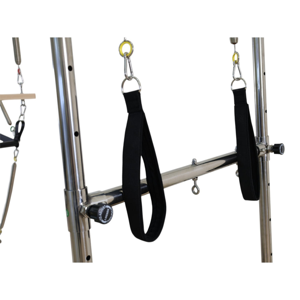 Push-through bar with black straps and colour-coded spring rings on the Cadillac reformer