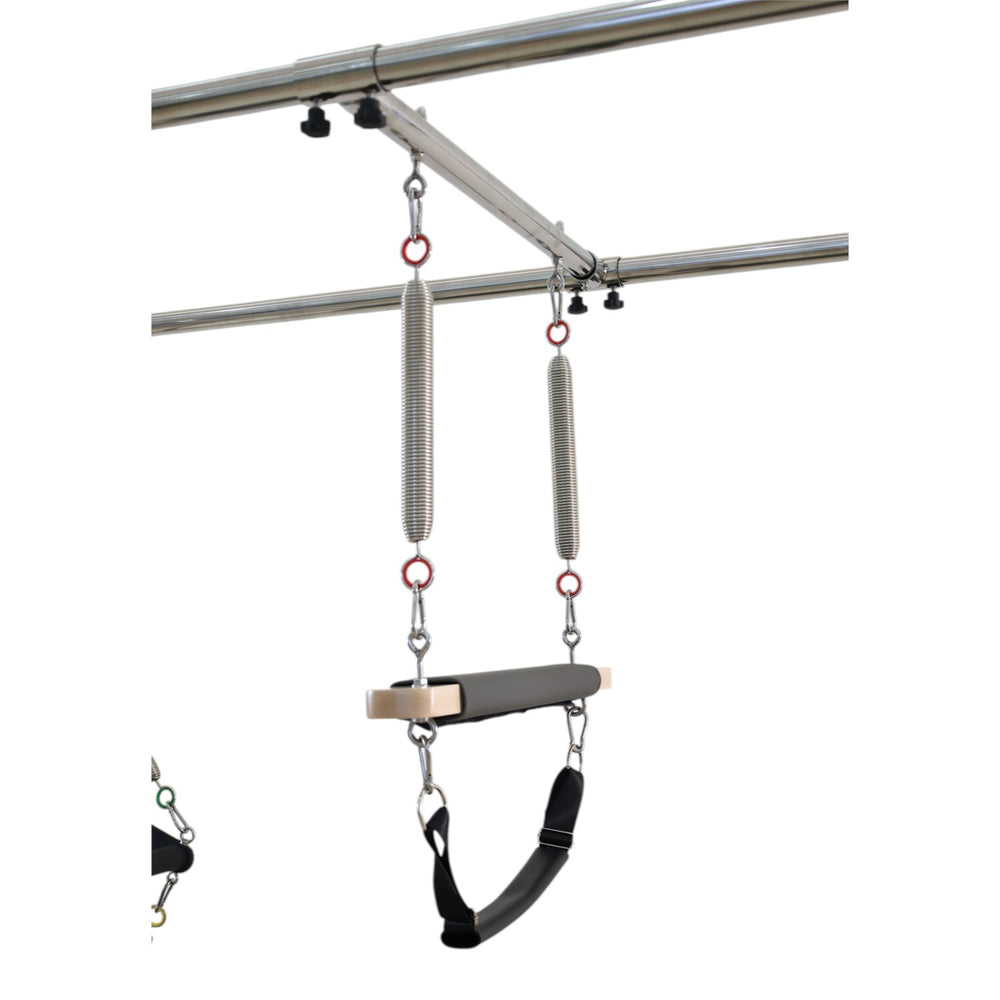Close-up of the roll-down bar attached to two chrome springs on the Cadillac reformer