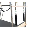 Close-up of the trapeze bar, springs and roll-down bar in the top corner of the Cadillac reformer frame