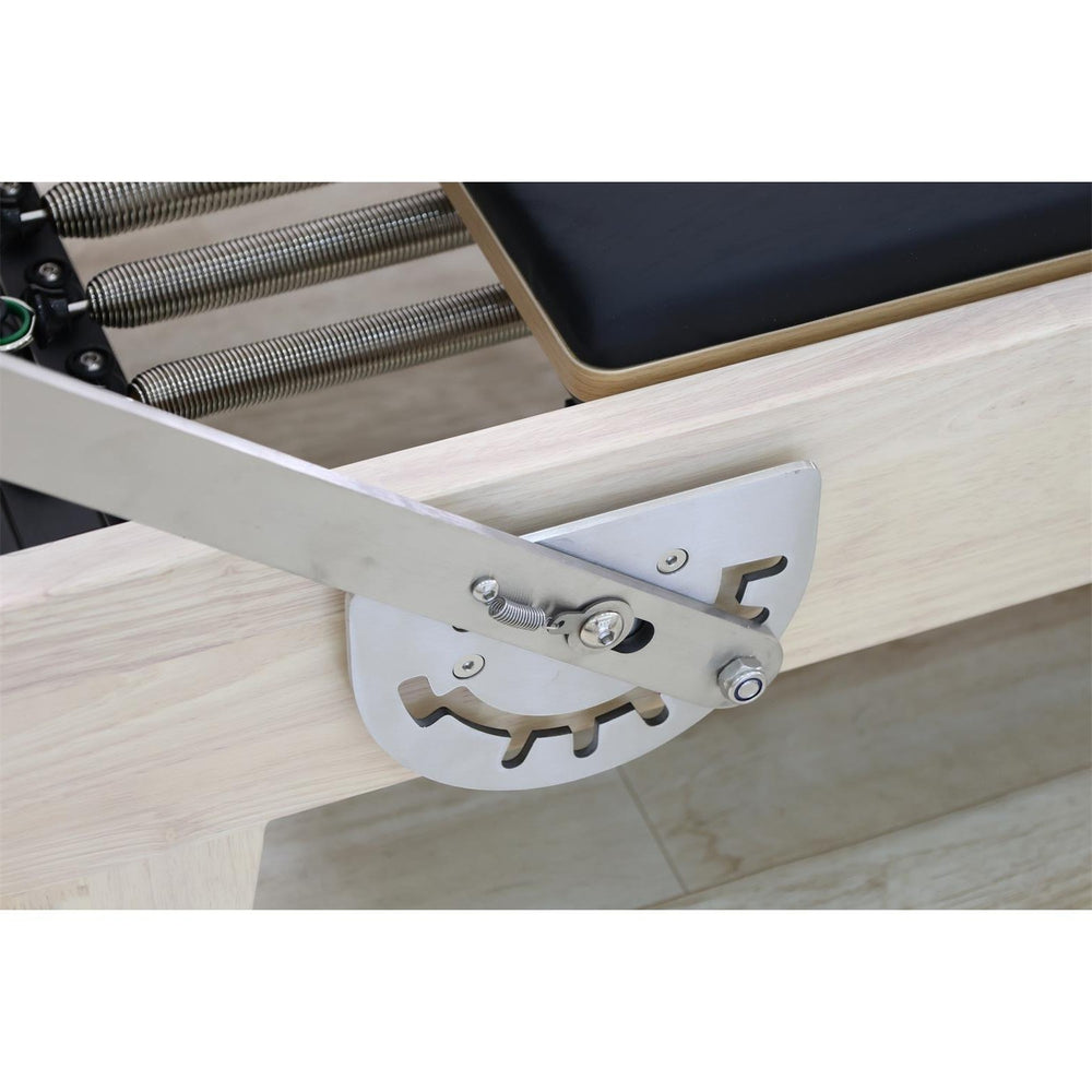 Gym Superstore professional wooden Pilates reformer showing the adjustable metal gear bar and spring resistance system.