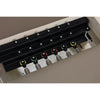 Gym Superstore wooden Pilates reformer showing the adjustable spring resistance system with multi-colored springs