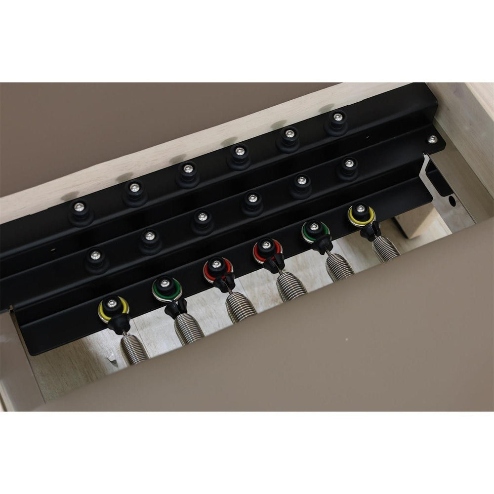 Gym Superstore wooden Pilates reformer showing the adjustable spring resistance system with multi-colored springs